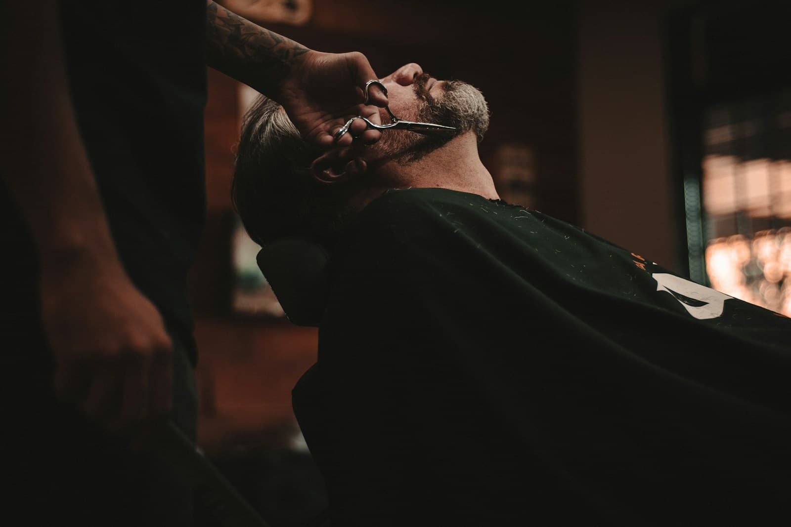 Master barber refining a gentleman's haircut